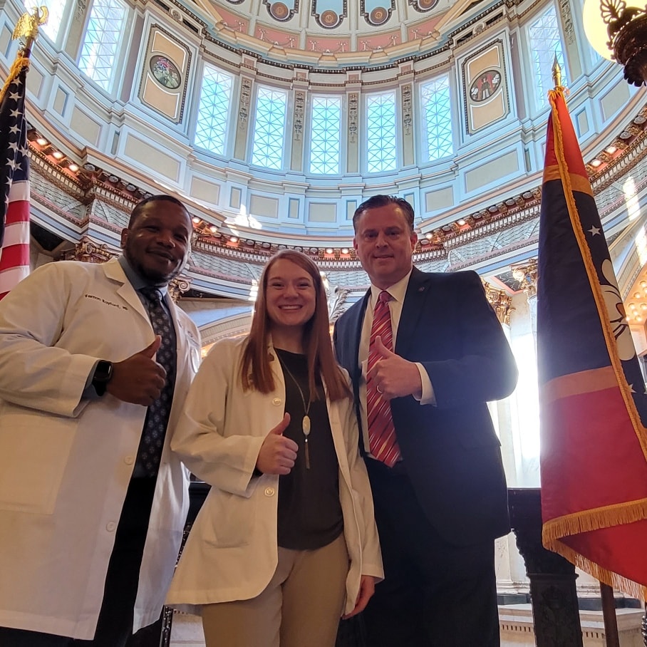 North Mississippi Health System Physician Dr. Vernon Rayford at the Mississippi State Capitol with Senator Chad McMahan and rural health student Sydney Franks.